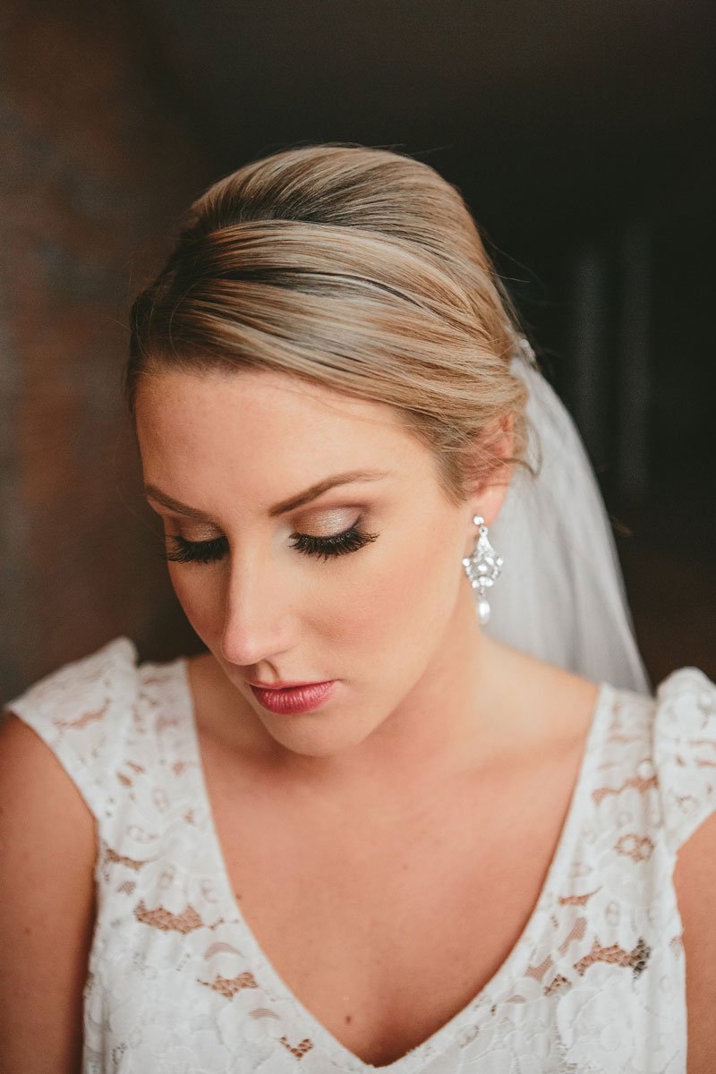 bride in a lace wedding dress wearing pearl antique inspired earrings rent jewelry at the pop up wedding shoppe vancouver