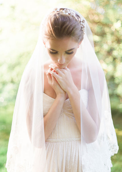 close up of bride wearing circular cut veil and headpiece