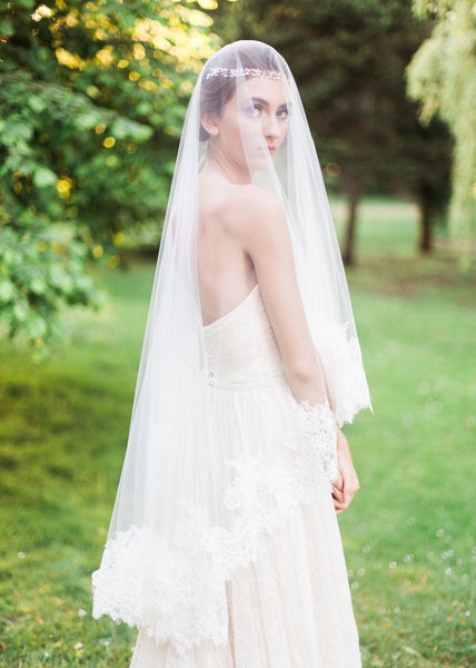 bride with sun shining wearing chantilly lace circular cut fingertip veil with blusher in front